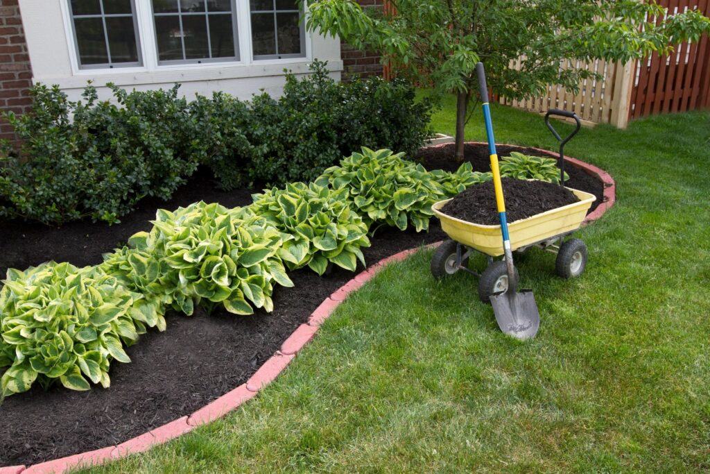 Bushes in a flower bed for Lawnmasters of Panama City.